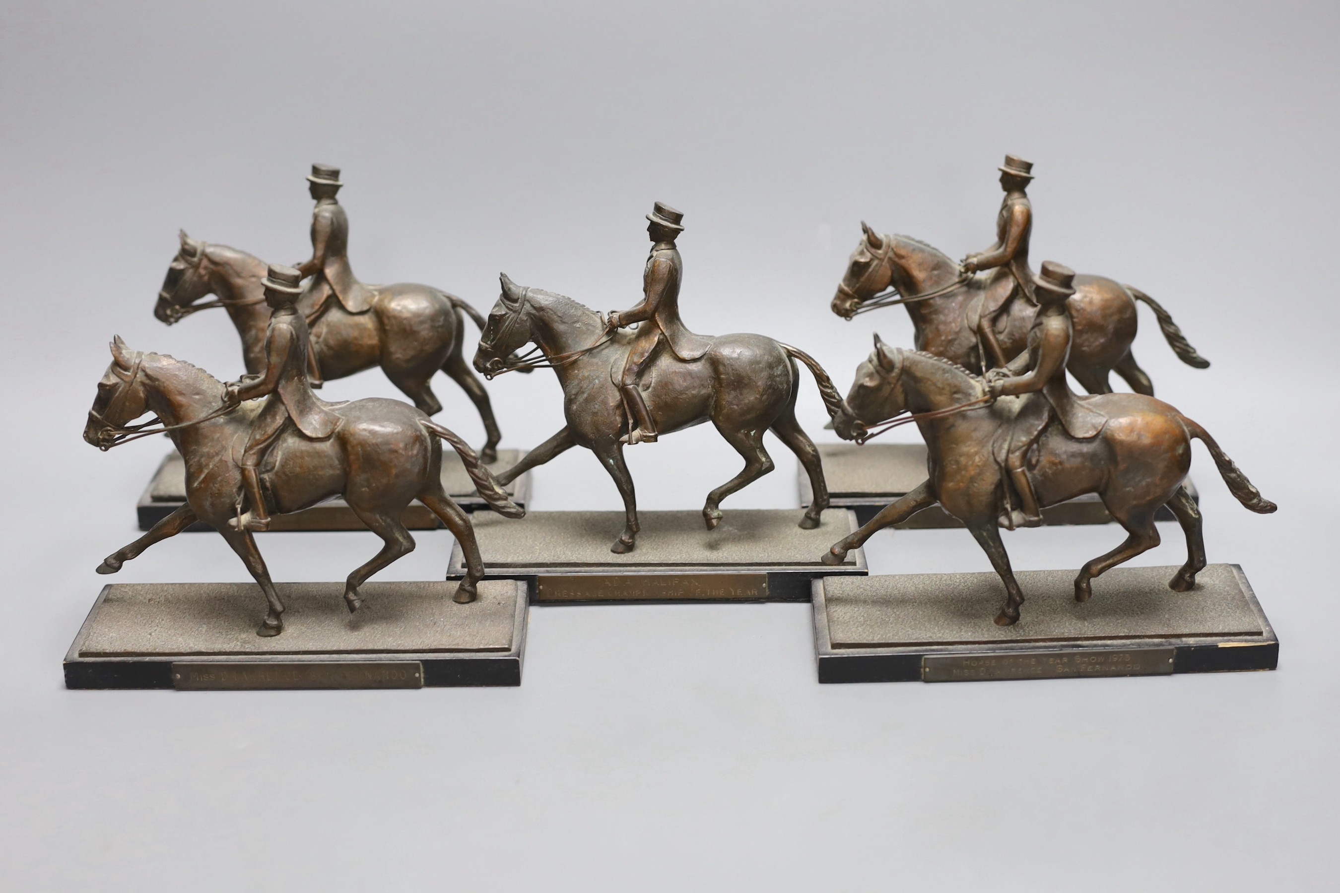 Five bronze spelter models of dressage horse and rider awarded to Domini Lawrence c.1970s, 15cm tall